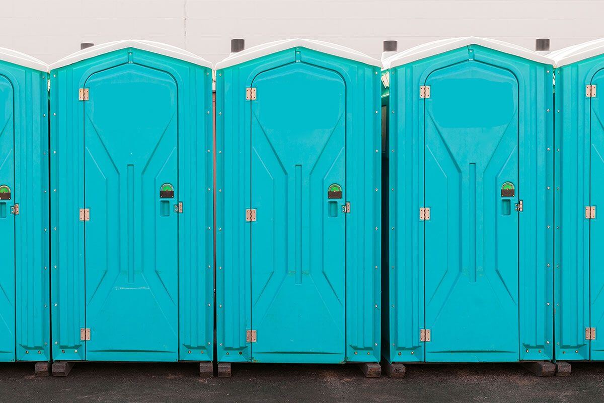 Rugged industrial portable restrooms at a commercial facility